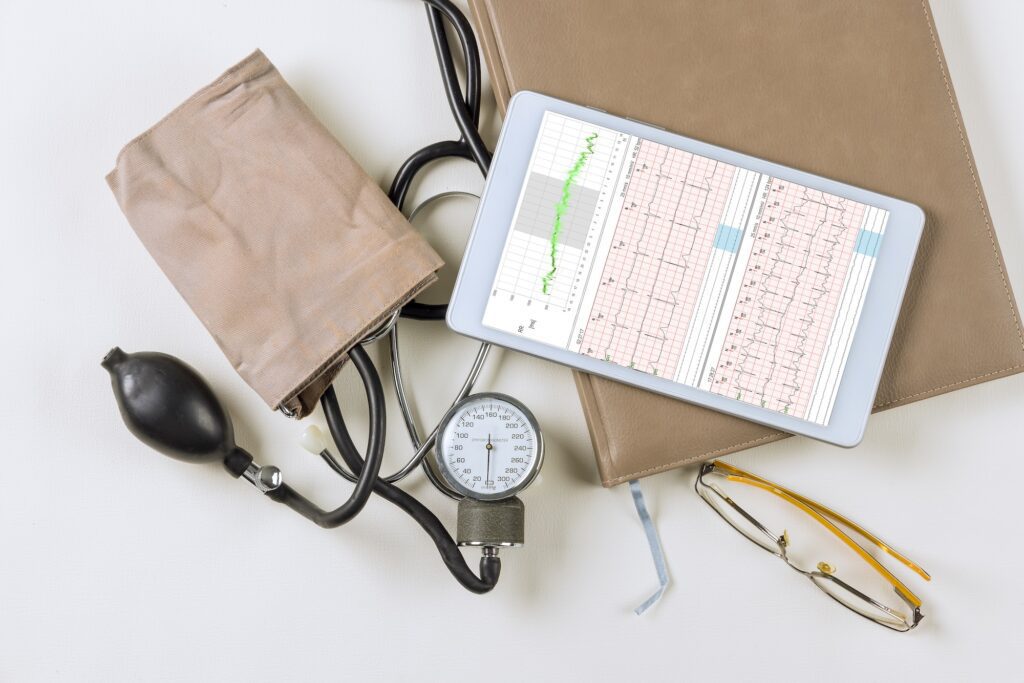 Doctor workplace with a stethoscope electrocardiogram heart rate readings