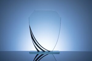 Elegant blank glass shield trophy on dark blue