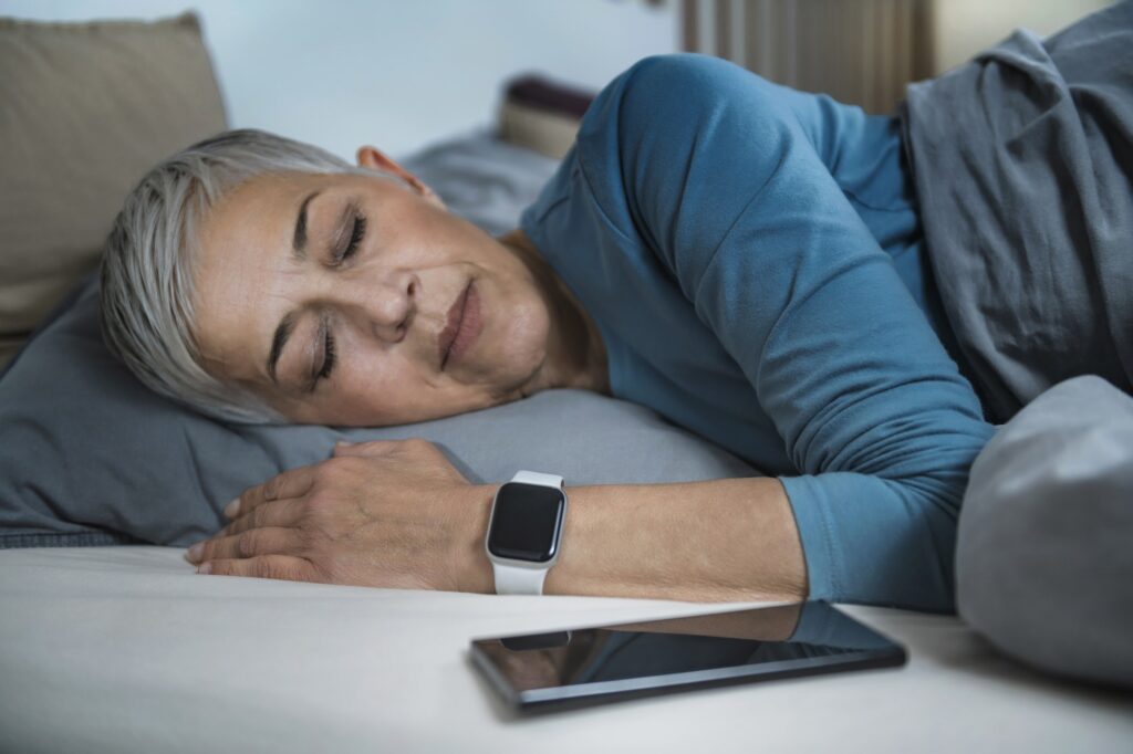 Sleep Apps - Tech-savvy Senior Woman Sleeping in Bed