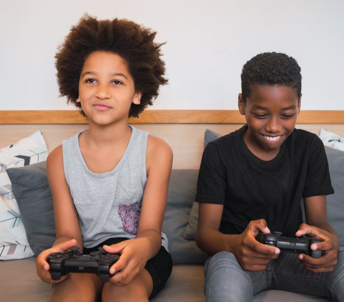 Two brothers playing video games at home.